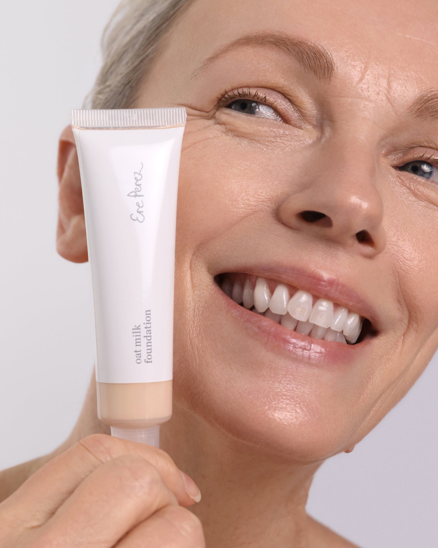 Natural &amp; delicate oat milk foundation applied on skin for clear complexion  