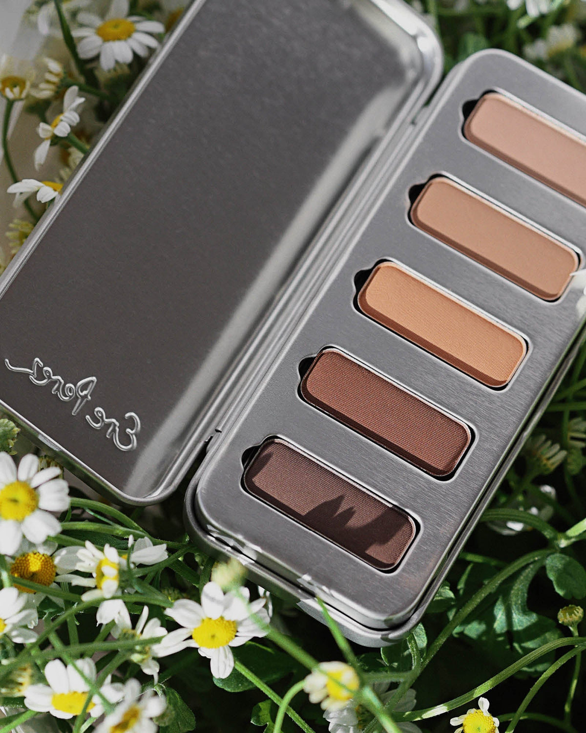 Element Matte Chamomile Eye Palette displayed among fresh chamomile flowers. #shade_element-matte