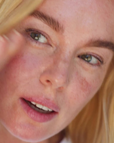 bottle of organic Australian blue cypress face nectar being applied with steel gua-sha