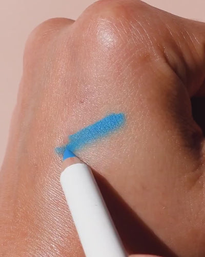 swatch of blue jojoba eye pencil by Ere Perez applied and smudged on eye for a refreshed smokey look 