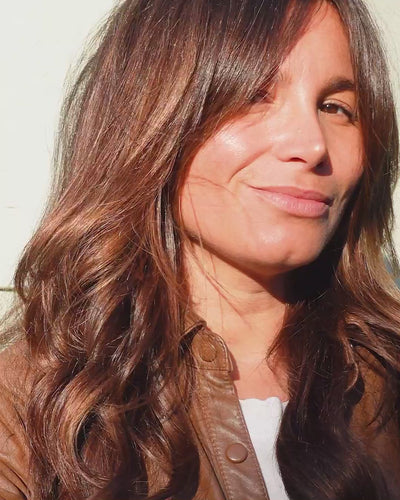 Ere Perez organic beetroot cheek &amp; lip tint applied on the skin for a pop of colour 